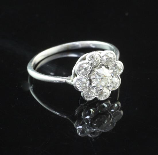 A white gold and diamond cluster ring, size O.